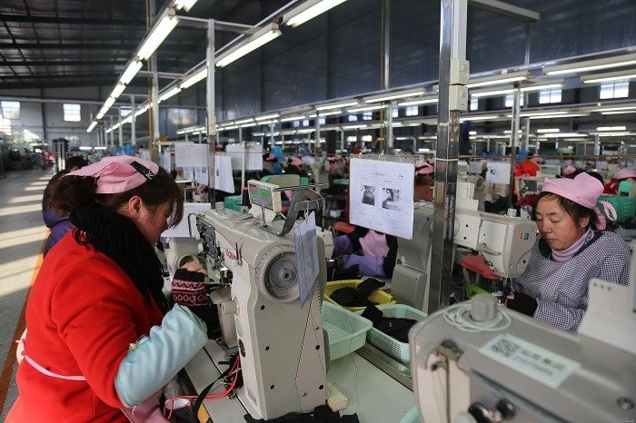 EAXIN footwear factory showing shoe production line and skilled workers