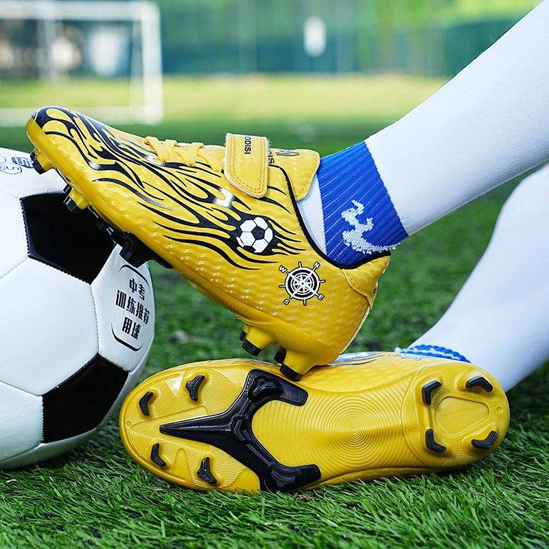 Professional football boots with bladed studs designed for traction, acceleration, and directional stability