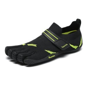 Adventurer wearing lightweight five finger water shoes on beach, ready for kayaking